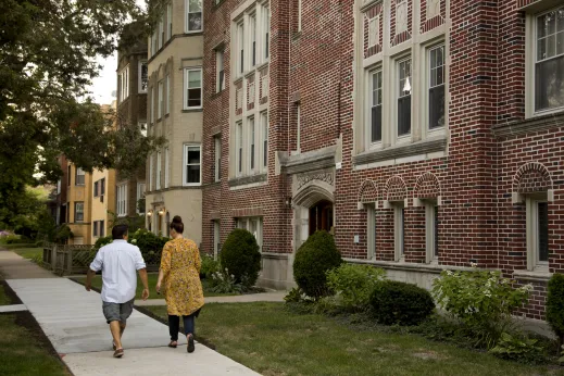 Couple walking in front of apartment building in West Ridge Chicago