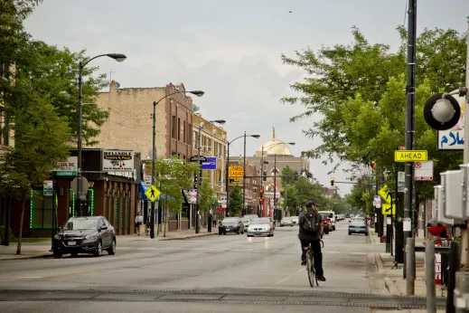 Cyclist riding on Kedzie Ave in Albany Park Chicago