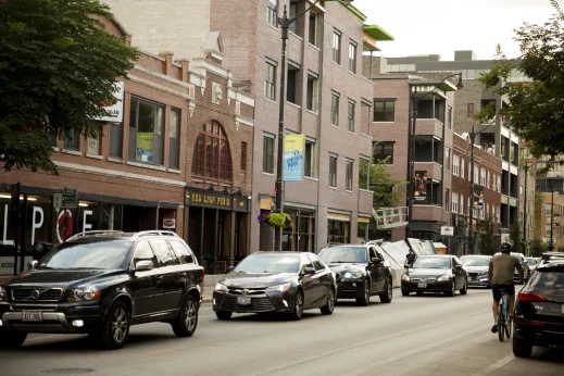 Cyclist and cars on N Lincoln Ave in DePaul Chicago