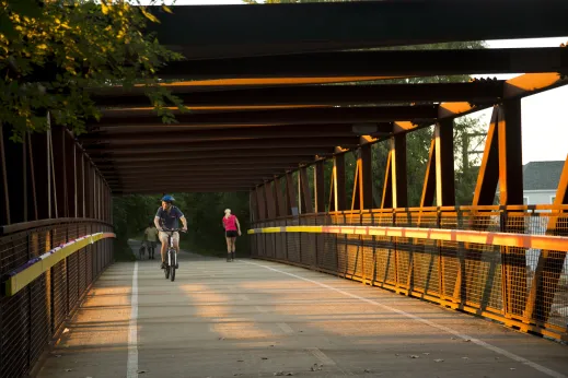 Cyclist crossing bridge over W Peterson Ave in Sauganash