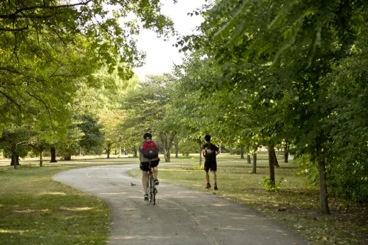 Cyclist jogger bike path in Budlong Woods Chicago