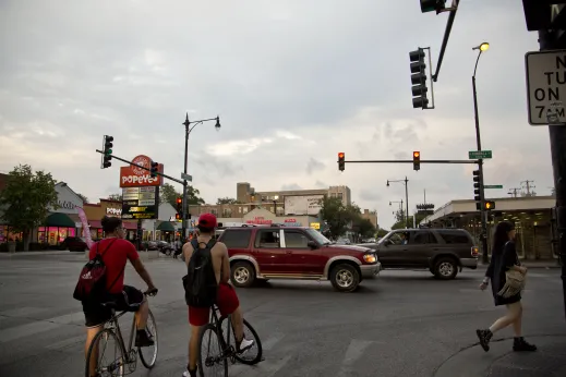 Cyclists wait at red light near Kimball Station in Albany Park Chicago