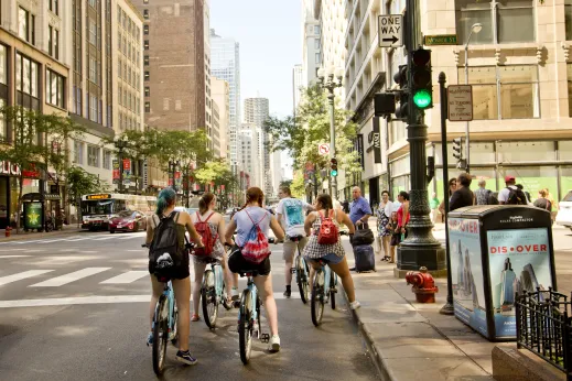 Cyclists on Divvy Bikes on Monroe and State Street in Chicago Loop