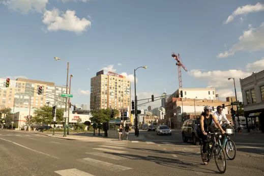 Cyclists and traffic on N Milwaukee Ave and W Chicago Ave intersection and traffic light in River West