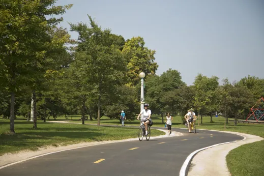 Cyclists and jogger lakefront path in Margate Park Chicago