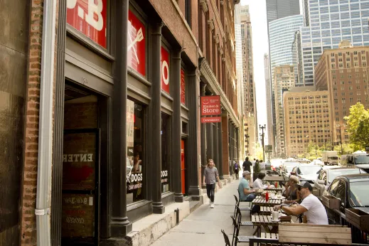 Diners eating at outdoor patio seating on North Franklin Street in Chicago Loop