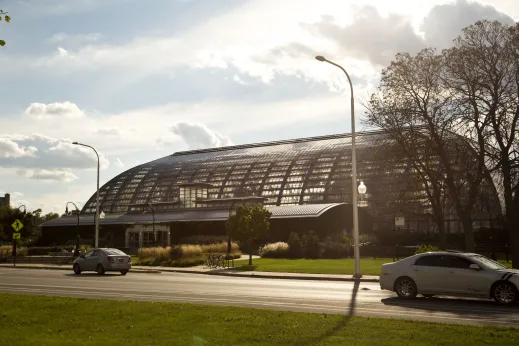 Exterior of Garfield Park Conservatory greenhouse by apartments in East Garfield Park Chicago