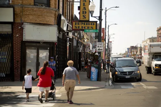 Family crossing South Trumbull Avenue intersection in Little Village Chicago