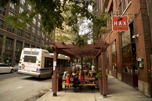 Family dining on outdoor patio seating at Hax restaurant in Printer's Row Chicago