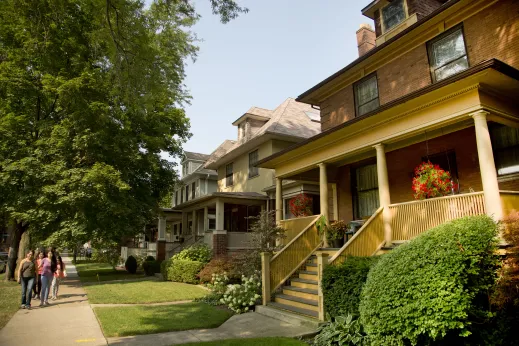 Family walking in front of historic homes in Lakewood Balmoral