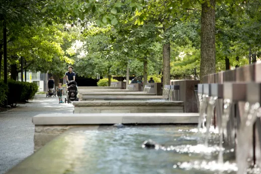 Family walking by public fountain park in Lakeshore East Chicago