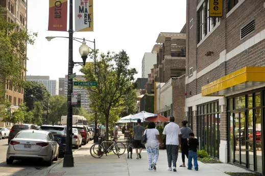 Family walking on sidewalk on Sheridan Road in Margate Park Chicago