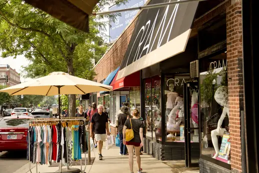 Fashion boutique entrance and pedestrians window shopping in Lakeview Chicago