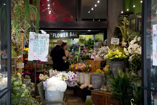 Flowers and garden shop display with customer browsing on E Ohio St in Streeterville