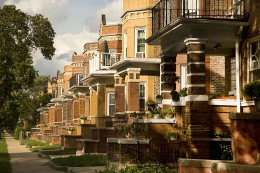 Front porches of vintage two flat apartments on neighborhood street in Austin Chicago