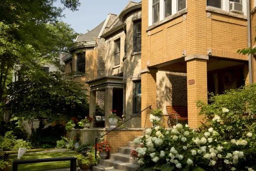 Hydrangeas and potted flowers on front porches in historic brick apartments in Lakewood Balmoral