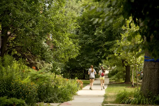 Joggers with dog on sidewalk in Albany Park Chicago