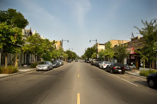 Local businesses and store fronts with cars parked in Hollywood Park