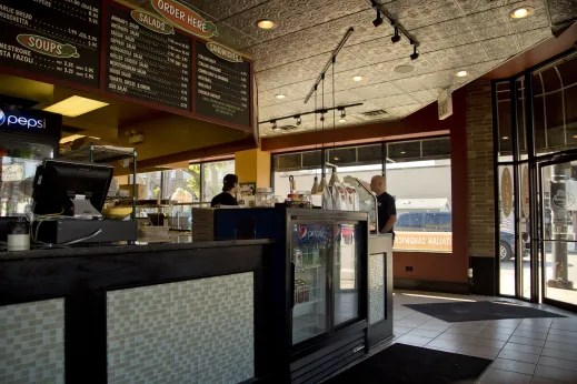 Local eatery interior with a customer ordering lunch in Edison Park