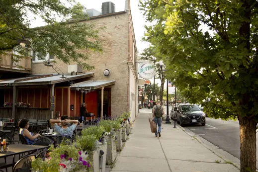 Man carrying guitar on North Lincoln Avenue in Lincoln Square Chicago