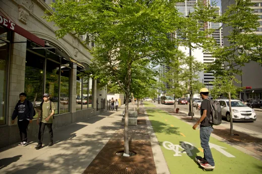 Man rides skateboard in bike lane on W Roosevelt Rd in the South Loop Chicago