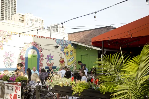 Mexican art outdoor mural at restaurant with patio seating in Old Town Chicago