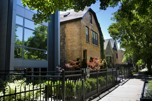 Modern apartment next to vintage brick house and fences in Ukrainian Village Chicago