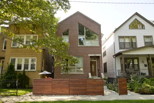 Modern single family home beside a vintage two flat on neighborhood street in Mayfair Chicago
