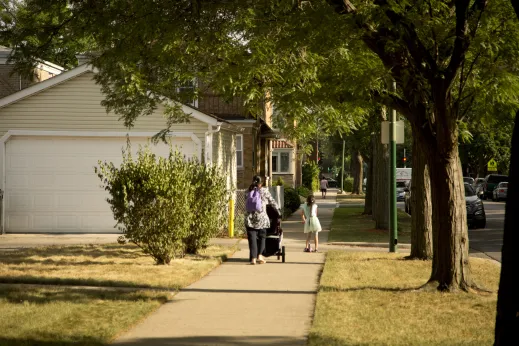 Mother and daughter walking down street in Budlong Woods Chicago