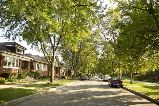 Neighborhood street cars parked on either side of road in North Mayfair