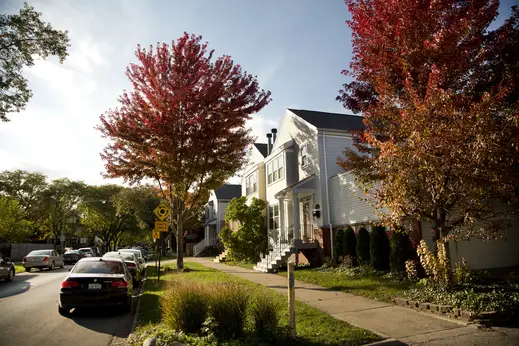 Neighborhood street with cars parked outside of homes and apartments in Old Irving Park Chicago