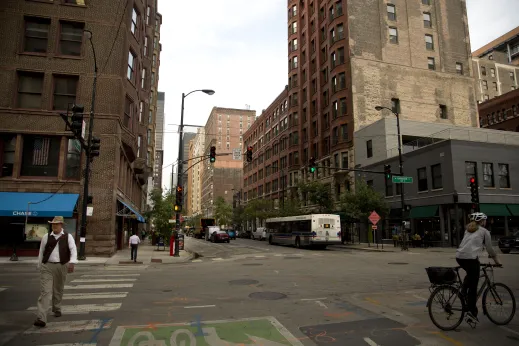 Pedestrian cyclist crossing the intersection on West Harrison Street in Printer's Row