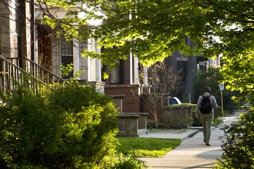 Pedestrian walks in front of apartments in Logan Square Chicago