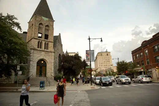 Pedestrians crossing 53rd Street and Blackstone Ave with United Church in the background in Hyde Park