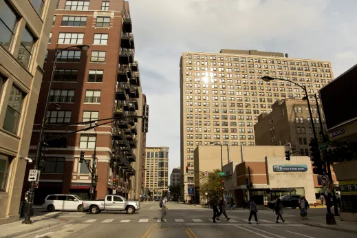 Pedestrians crossing West Harrison Street and South Clark Street in Printer's Row Chicago