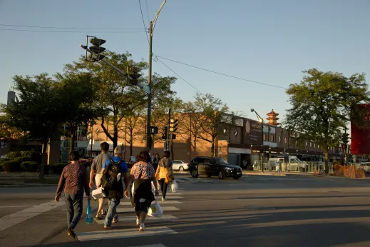 Pedestrians on crosswalk at S Archer Ave in Chinatown