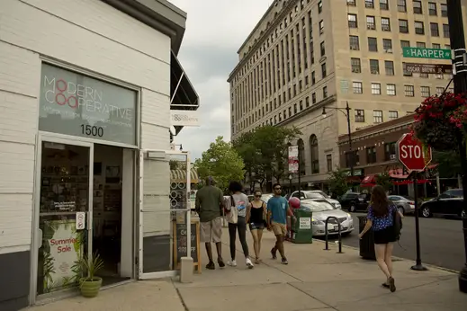 Pedestrians outside Modern Cooperative entrance in Hyde Park Chicago