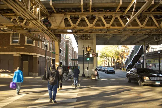 Pedestrians walk below elevated Green Line platform near King Drive station in Woodlawn Chicago