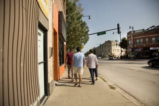 Pedestrians walking on W Lawrence Ave outside local businesses in Mayfair Chicago