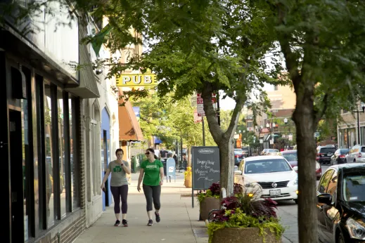 Pedestrians waling outside local businesses on North Lincoln Avenue in North Center