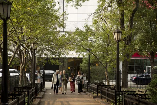 Pedestrians walking in park in the Gold Coast Chicago