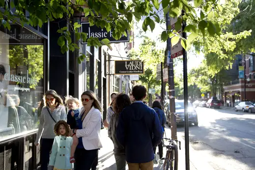 Pedestrians walking by shop front in Lincoln Park Chicago