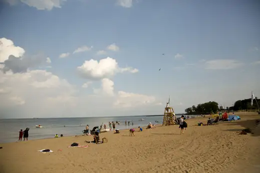 People on the beach and the lifeguard tower in Hyde Park Chicago