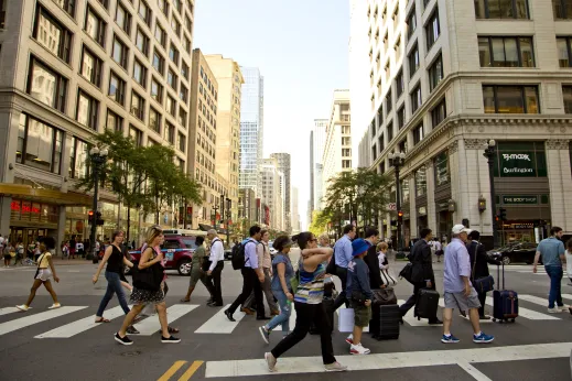 People crossing North State Street intersection in downtown Chicago Loop