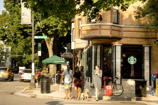 People with dogs crossing N Seeley Ave outside Starbucks Coffee in Roscoe Village