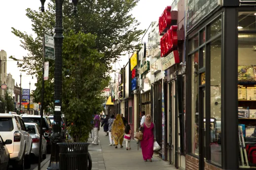 People walking in front of local shops on W Devon Ave in West Ridge Chicago