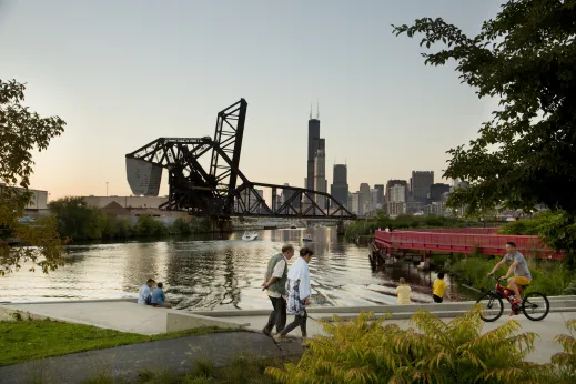 People walking, sitting, and cycling in Ping Tom Park on South Branch of Chicago River in Chinatown