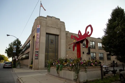 Red steel sculpture outside art deco building on S Morgan St in Bridgeport Chicago