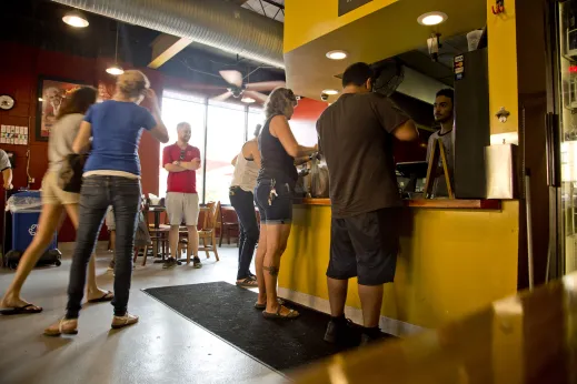 Restaurant customers in cash register line at Smoque BBQ in Irving Park