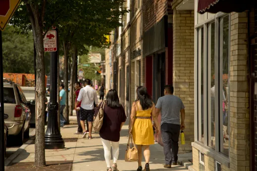 Shoppers walking on sidewalk outside local businesses on N Clark St in Sheridan Park